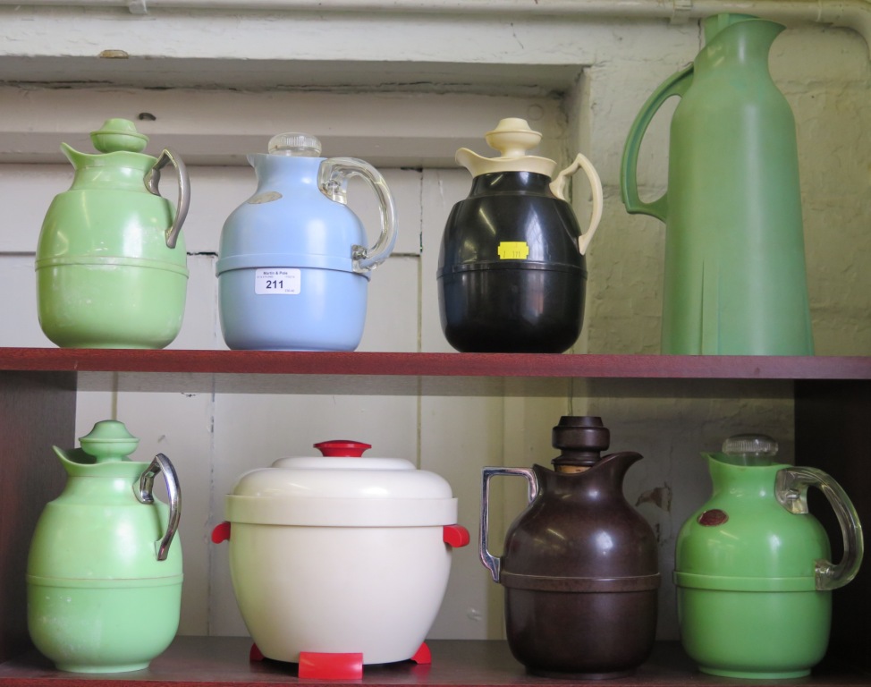 Seven vintage Thermos jugs and a white plastic Thermos bowl and lid