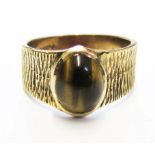 A 9 carat gold bark finnish ring set with tigers eye