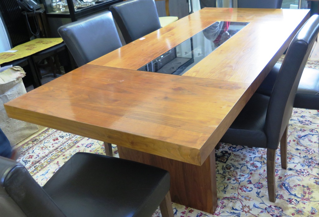 A walnut dining table, the rectangular top with tinted glass centre on rectangular supports, 90cm