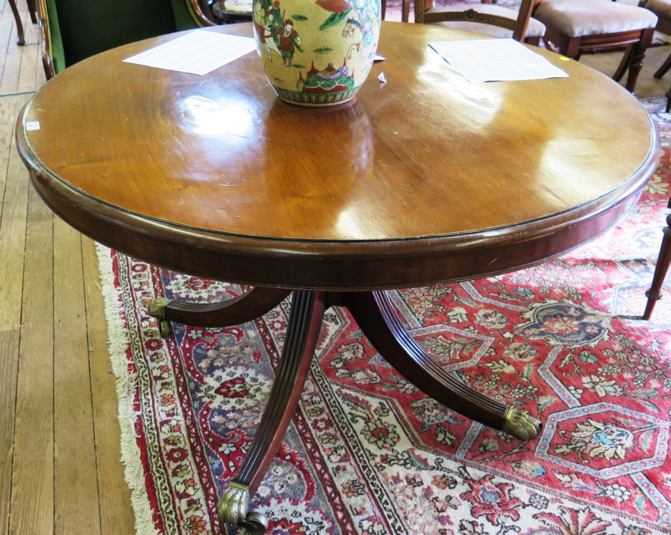 A mahogany circular snaptop breakfast table, the Victorian circular top over a later turned stem