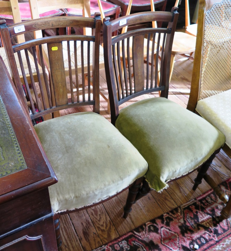 A pair of Edwardian side chairs, the anthemion decorated top rails above rail backs depicting urns