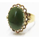 A 9 carat gold ring set with an oval cut nephrite jade stone