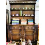 An oak dresser and rack, the fluted cornice over two shelves, the base with two fluted frieze