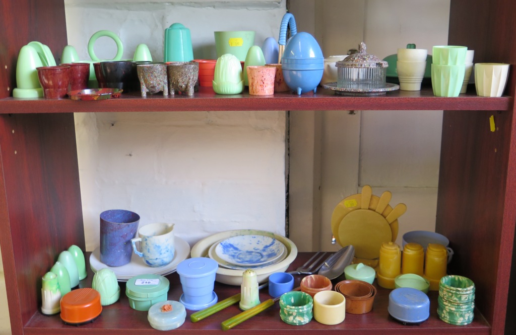 A variety of vintage plastics, including egg cups, condiment sets, plates and saucers