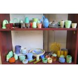 A variety of vintage plastics, including egg cups, condiment sets, plates and saucers