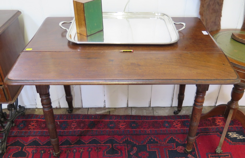 A Victorian mahogany Pembroke table, with rounded leaves, single frieze drawer and ring turned legs,