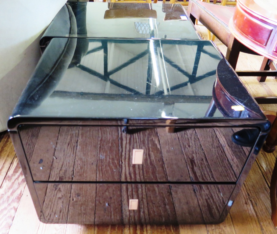 A pair of black laminate bedside tables with rounded corners and two drawers