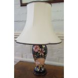 A Moorcroft Oberon pattern table lamp, of baluster form with floral decoration on a dark green and