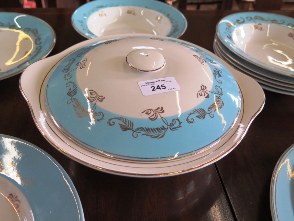 A Barratt's Delphatic white part dinner service with blueband and foliate gilt decoration, including