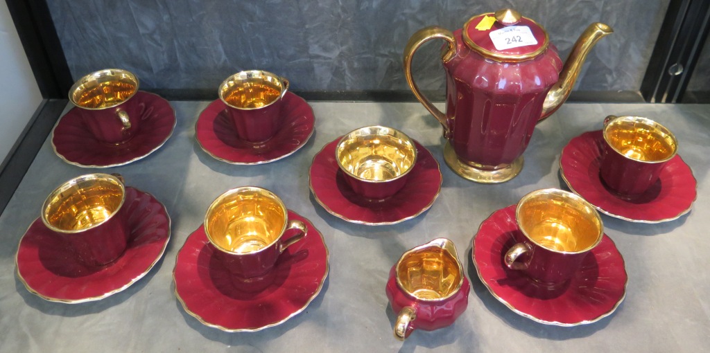 A Wade coffee service, with crimson fluted sides and gilded interiors, six cups and saucers,