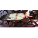 A mahogany veneered and leather topped coffee table, with D-ends and twin reeded tripod bases with