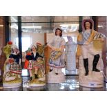 A large pair of 19th century Staffordshire flat backs of a man and woman carrying fish in baskets