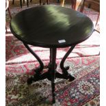 A Victorian style stained wood occasional table, the circular top over four scroll supports and legs