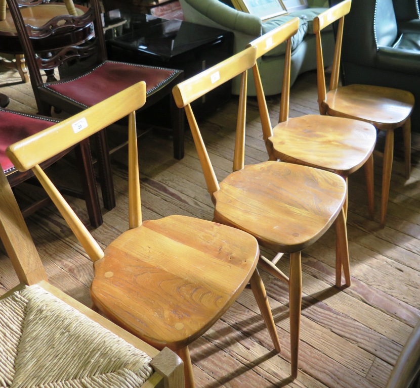 A set of four Ercol beech and elm stacking Windsor chairs, with single top rail backs, stamped Ercol