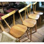 A set of four Ercol beech and elm stacking Windsor chairs, with single top rail backs, stamped Ercol