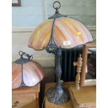 An Art Nouveau style bronzed metal table lamp, the mottled glass shade over a foliate and beaded