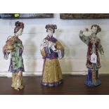 Three Chinese pottery figures depicting maidens carrying flowers, one carrying pot in full