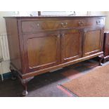 A 1920's mahogany sideboard, the rectangular top with beaded edge over two frieze drawers and