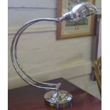 An Art Deco style nickel plated angle poise lamp, with C-shape support on circular base