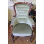 A Victorian mahogany spoonback armchair, the scrolling button back on moulded scroll supports and