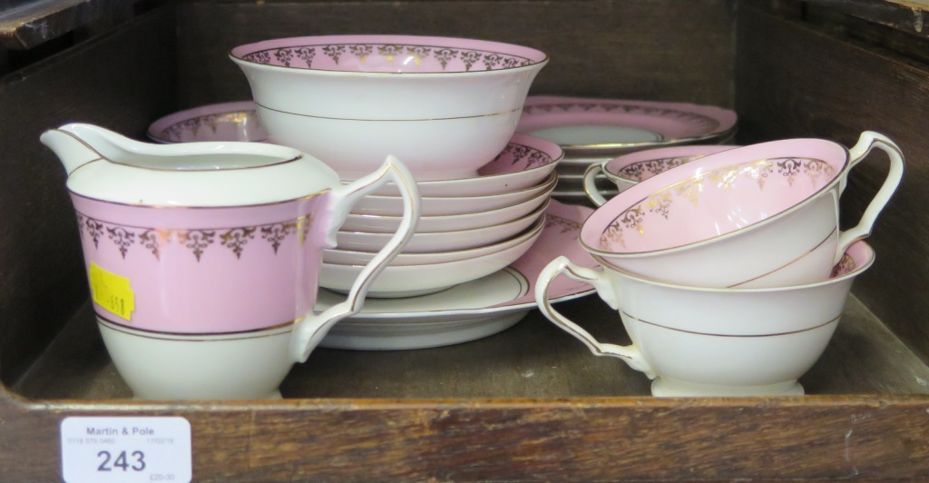 A Czechoslovakian pink and gilt tea service, for six plate settlings, with tea cups, saucers,