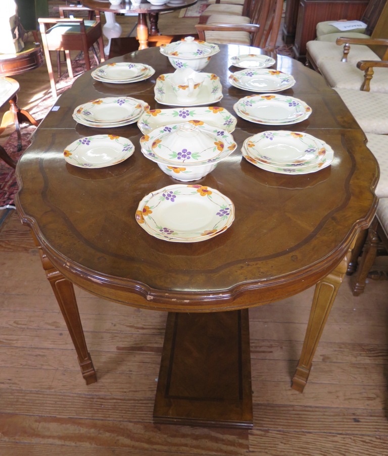 A French provincial style walnut dining room suite, comprising shaped oval extending dining table,