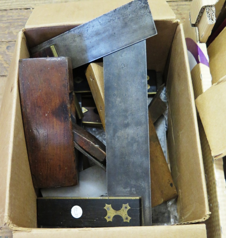 A collection of woodworking tools, including a brass and rosewood measure, three squares,