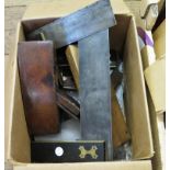 A collection of woodworking tools, including a brass and rosewood measure, three squares,
