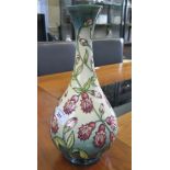 A Moorcroft 'Trial' vase, of bottle form with red bellfower decoration on a green and cream ground
