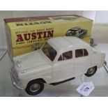 A Victory Industries off-white battery-operated Austin A40 Cambridge Saloon with red interior in
