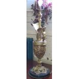 A gilt metal table lamp, in the form of a Rennaissance ewer, filled with cartouches of figures on