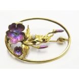 A gold coloured metal flower brooch set with a small diamond and enamel flowers