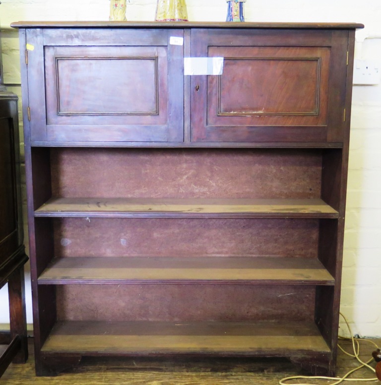 A mahogany open bookcase, with two panelled doors enclosing sheet music compartments over three open