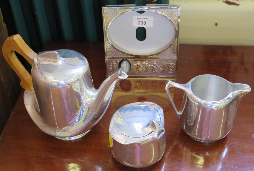 A Picquot ware three piece tea service, of organic form and a Wedgwood photo frame with jasper