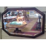 An oak octagonal wall mirror, the bevelled plate with a stepped frame, 38cm x 60cm