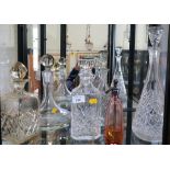 A glass ship's decanter and stopper, two square decanters and stoppers, a scent bottle and two other