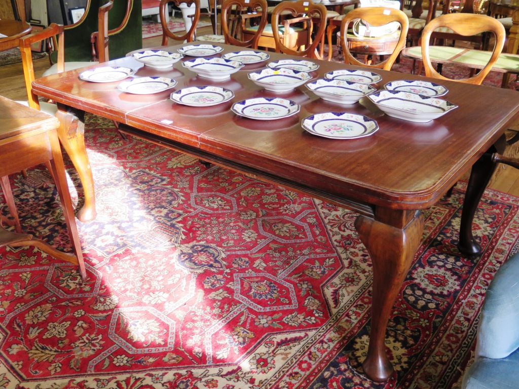 An early 20th century mahogany extending dining table, the rectangular top with rounded corners on