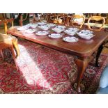 An early 20th century mahogany extending dining table, the rectangular top with rounded corners on