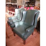 A pair of leather upholstered wing armchairs, on moulded square legs (2)