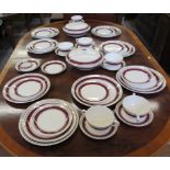 A Crown Ducal dinner service, with gilt and claret borders, including two tureens and covers