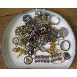 A large collection of costume jewellery in satin covered box