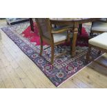 A large Persian Tabriz carpet, the red field with blue medallion and ivory spandrels with floral