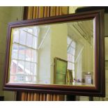 A modern mahogany framed rectangular wall mirror, with bevelled plate, gilt slip and moulded