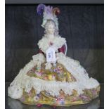 A German porcelain figure of a seated lady with exuberent lace and gold dress, 30cm high