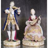 A pair of German porcelain figures playing the violin and the lute, violin player 40cm high