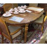 A French provincial style walnut dining room suite, comprising shaped oval extending dining table,