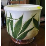 A Moorcroft planter, with green leaves on an ivory ground, impressed mark signed and dated 6.10.