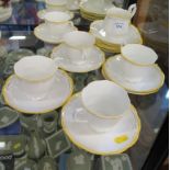 A Royal Albert service with yellow and gilt rims, for six places (one cup missing)