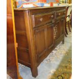 An Ercol dresser base, with two drawers and two panelled cupboard doors, 122cm wide