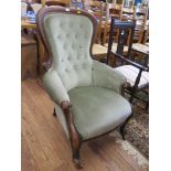 A Victorian mahogany spoonback armchair, the button upholstered back over moulded scroll arms and